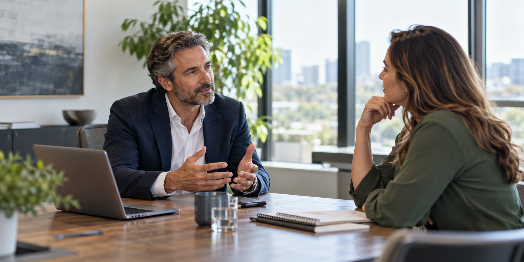 A consultant speaking with a client across a conference table